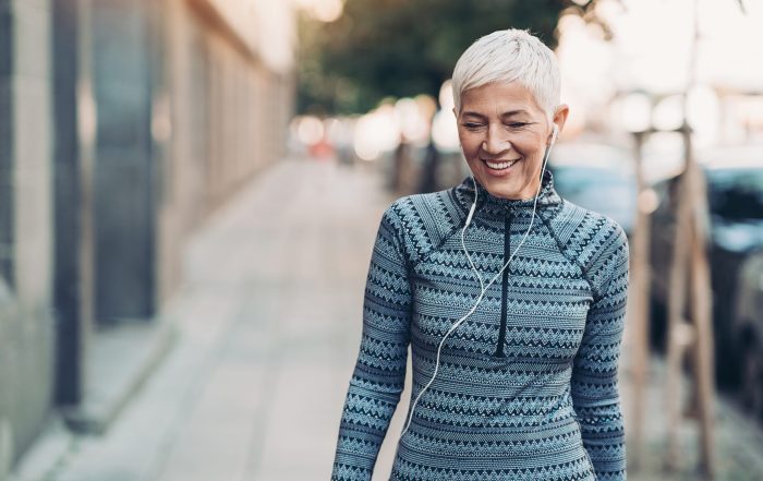 woman outside in active wear with headphones