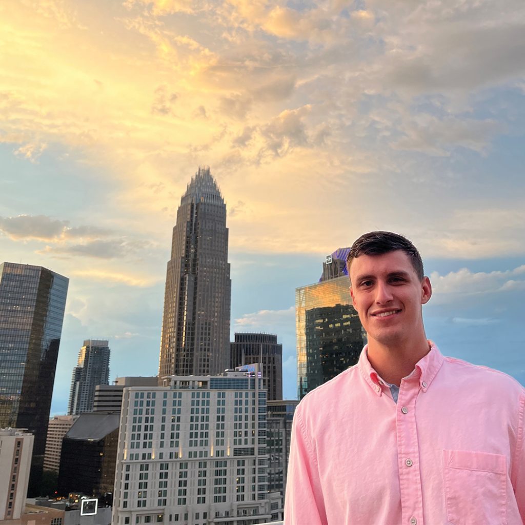 Scott M. standing in front of city skyline