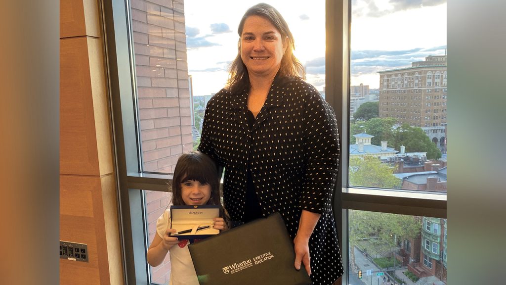 Christina S. holding certificate with daughter