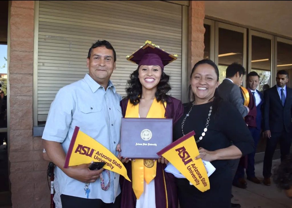 Angelica R. with parents at graduation