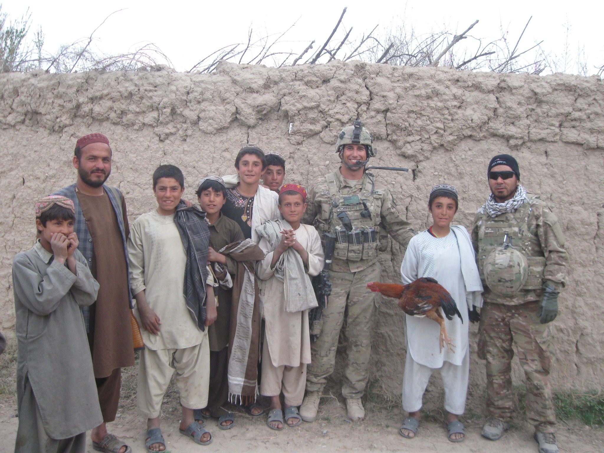 Mike S. on active duty in foreign country standing with local community