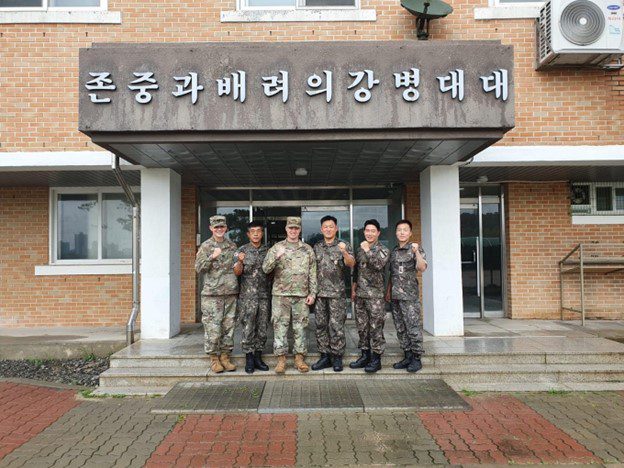 Sean E. in uniform with colleagues