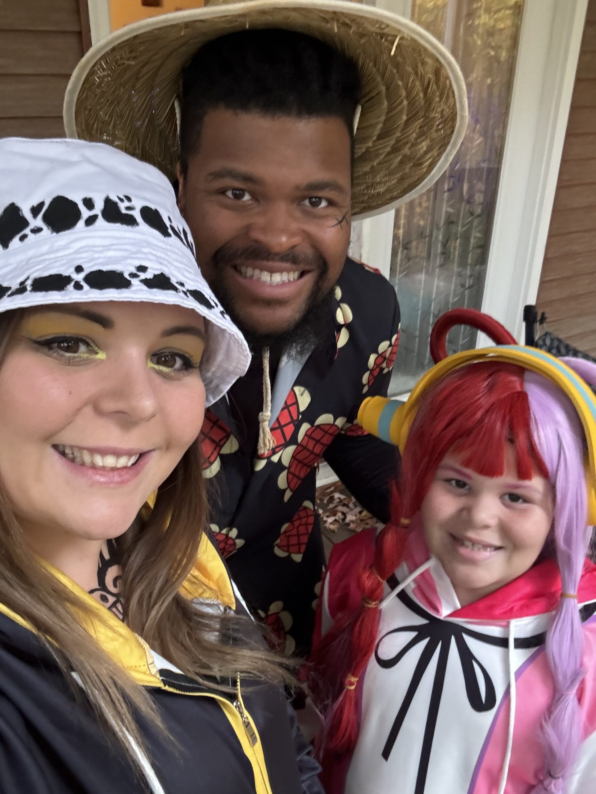 Carlos P. with wife and daughter in costumes