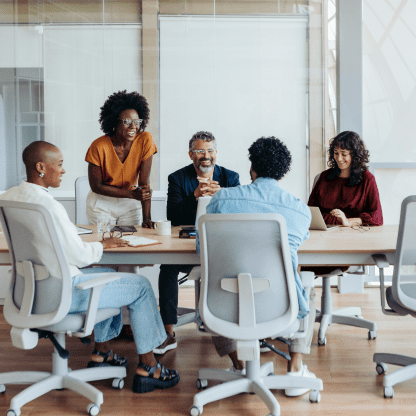 Group of diverse coworkers meeting in a conference room.