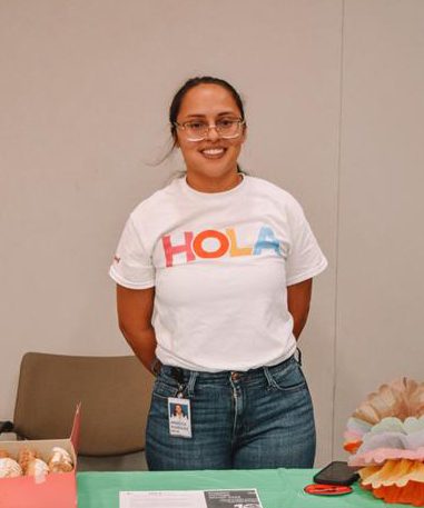 Angelica R. wearing HOLA t shirt at an event