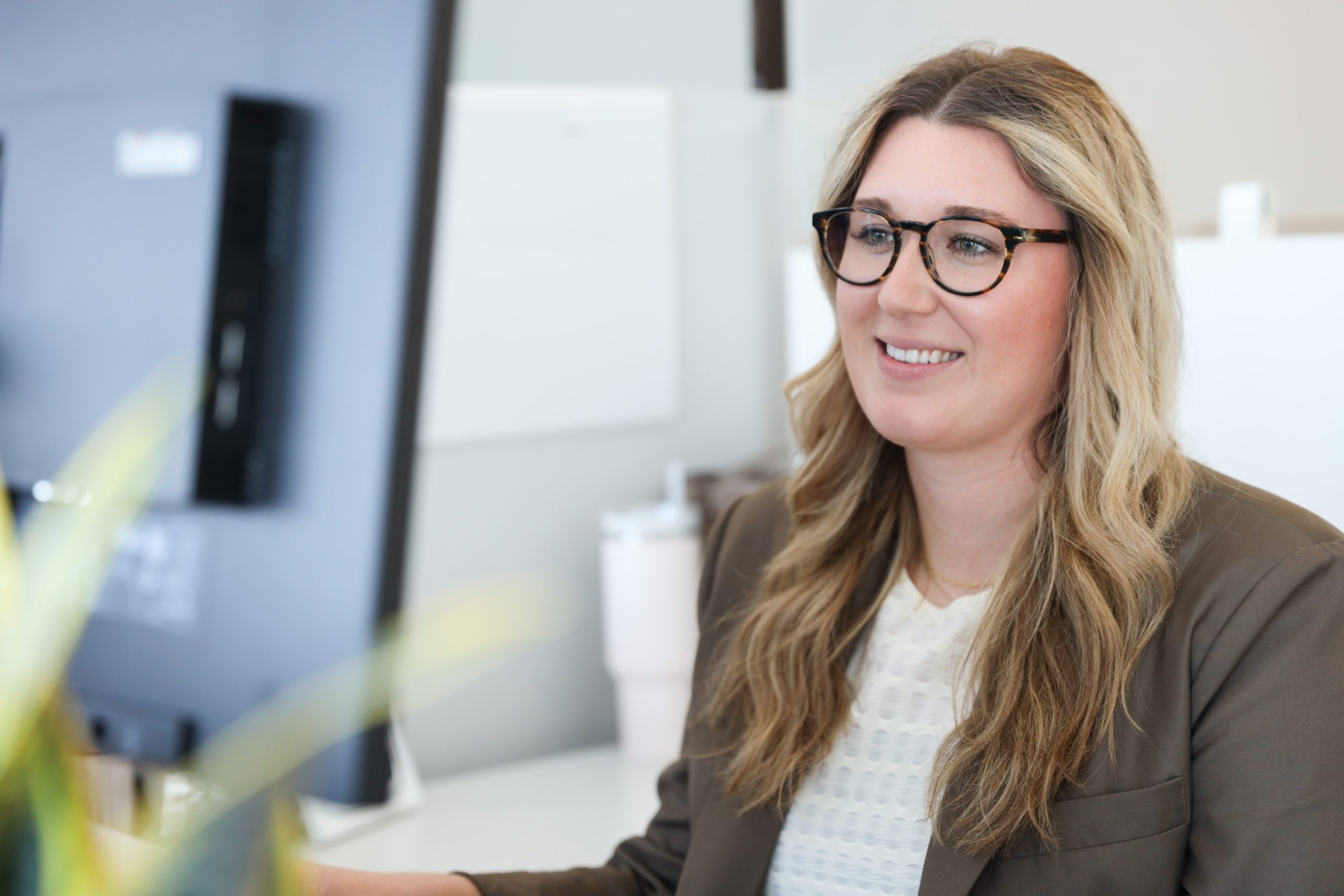 Woman smiling while working on computer.