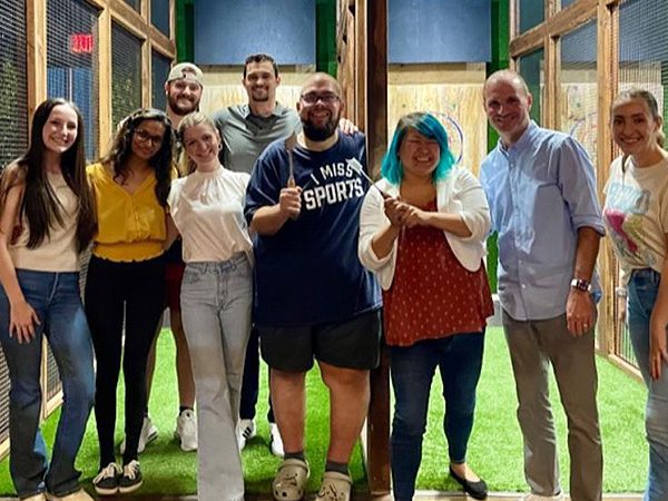 Group photo of Maycee and her colleagues enjoying a team-building activity